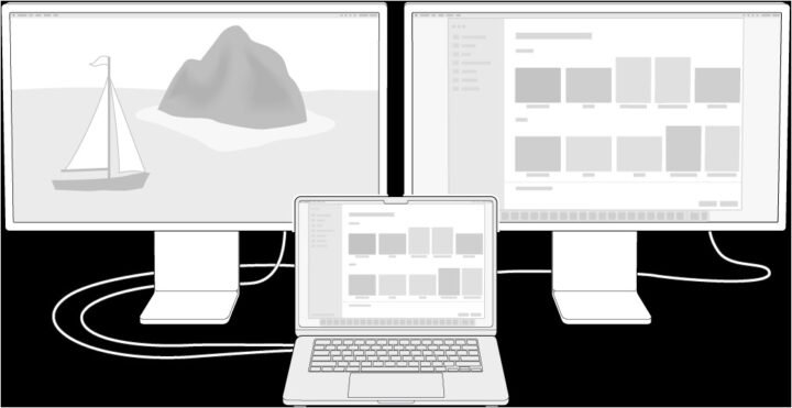 MacBook Air đặt cạnh màn hình phụ lớn đang hiển thị nội dung